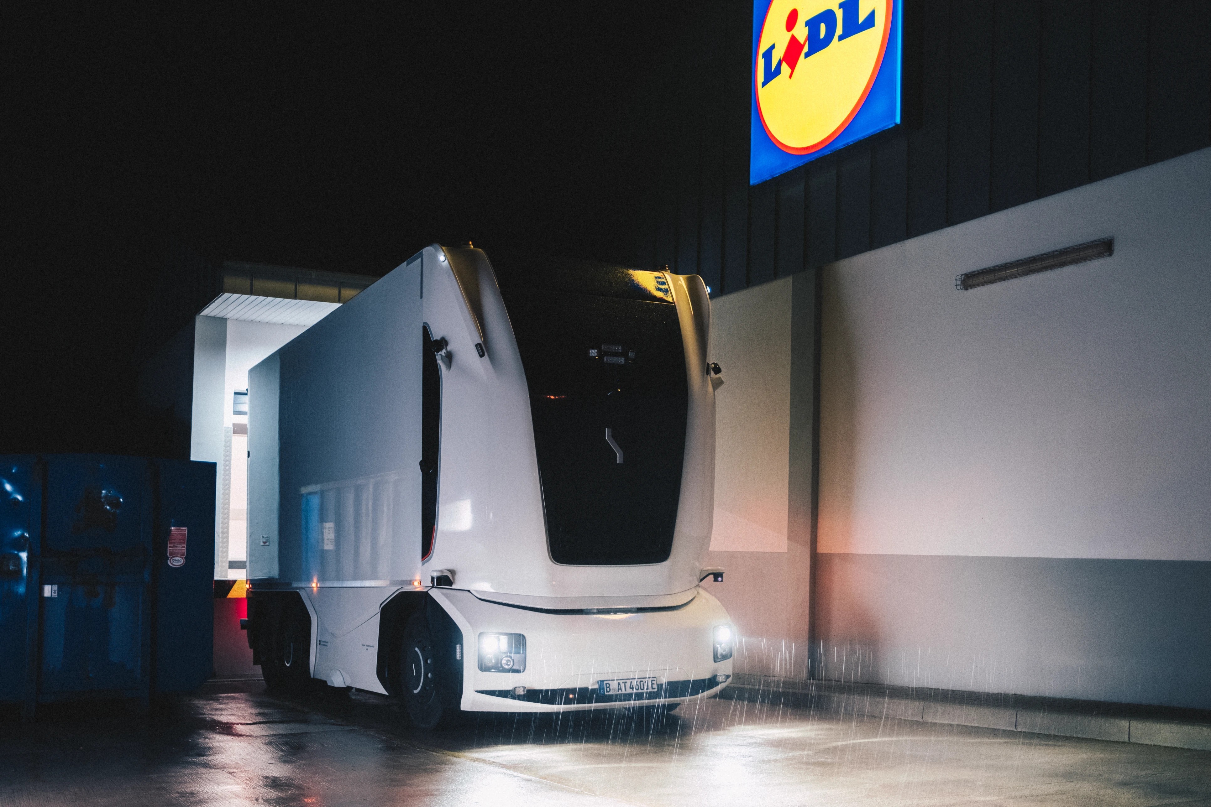 Einride cab-less autonomous truck at a Lidl store at night, with no driver cabin.