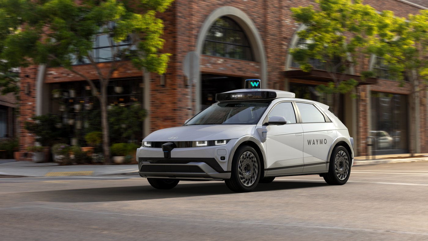 A white Waymo-branded Hyundai Ioniq 5 robotaxi.